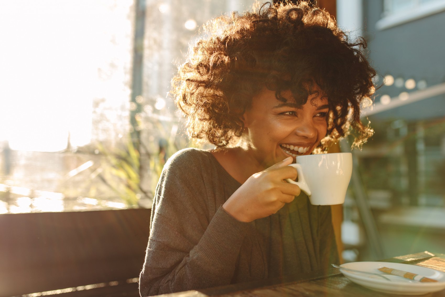 Woman Drinking Coffee at a Coffee Shop