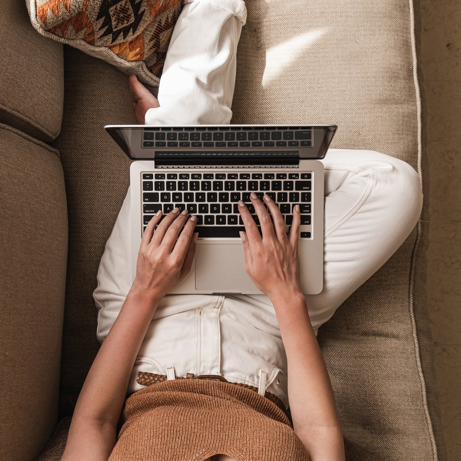 Woman Using a Laptop on the Couch